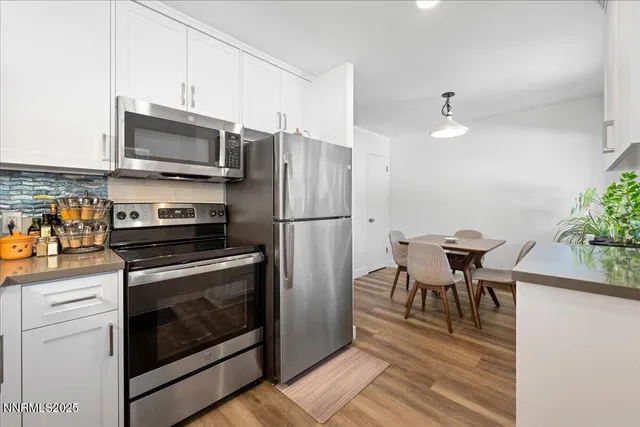 a kitchen with a refrigerator stove and microwave