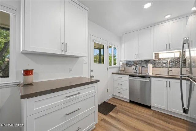 a kitchen with granite countertop white cabinets and white appliances