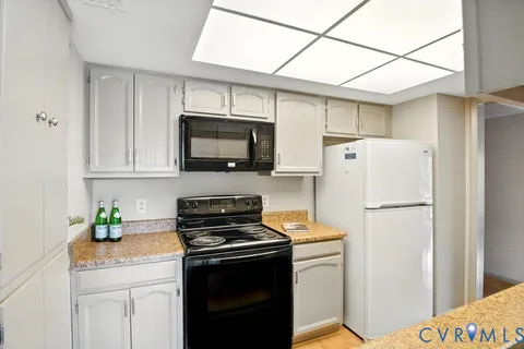 a kitchen with stainless steel appliances a refrigerator sink stove and microwave
