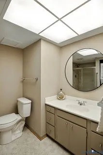 a bathroom with a toilet sink and mirror