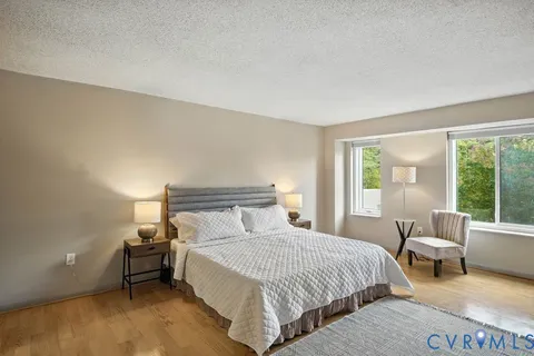 a bedroom with a bed and a couch