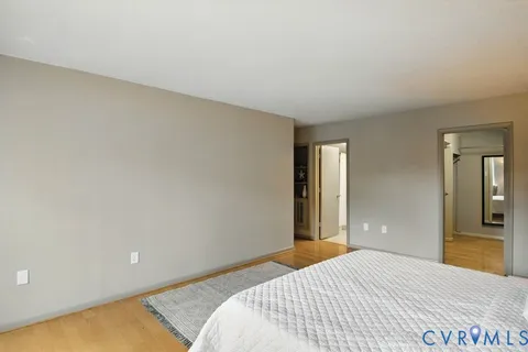 a bedroom with a bed and a mirror