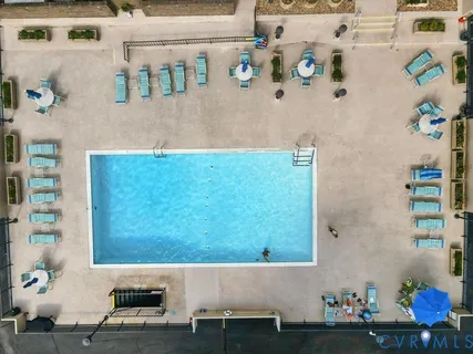 an aerial view of ocean and residential houses with outdoor space