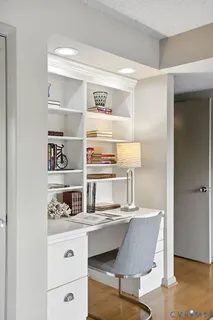 a room with kitchen island stainless steel appliances wooden floor and view living room