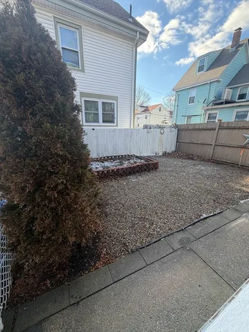 a view of a backyard with sitting area