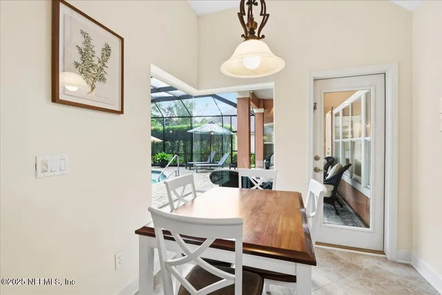 a view of a dining room with furniture wooden floor and a chandelier