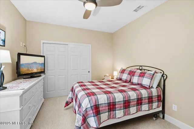 a view of a workspace with furniture and a ceiling fan