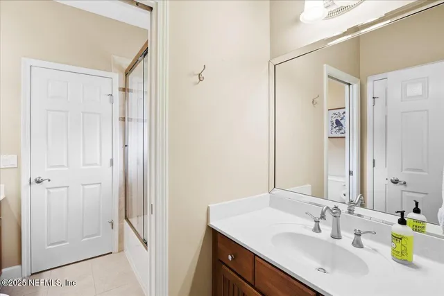 a bedroom with a bed and ceiling fan