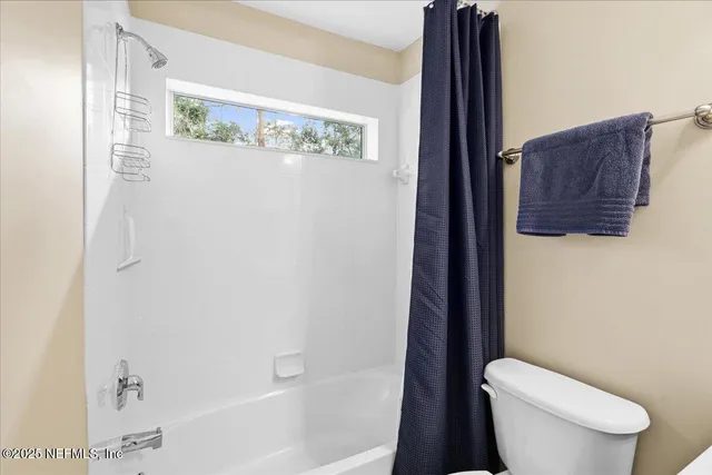 an aerial view of a house with garden space and street view