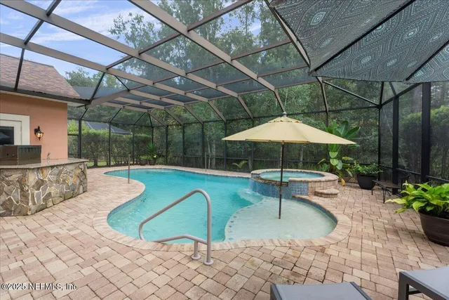 a view of a house with a big yard plants and large trees