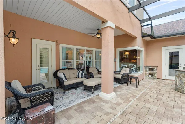 an aerial view of a house with swimming pool and outdoor seating