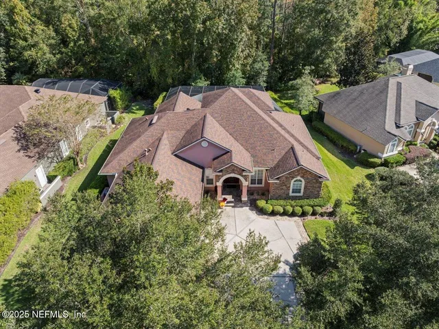 an aerial view of a house with a yard