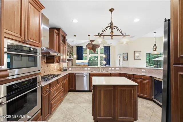 a kitchen with a sink stove and refrigerator