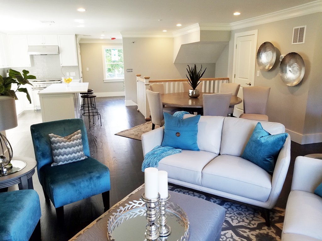 a living room with furniture kitchen view and a table