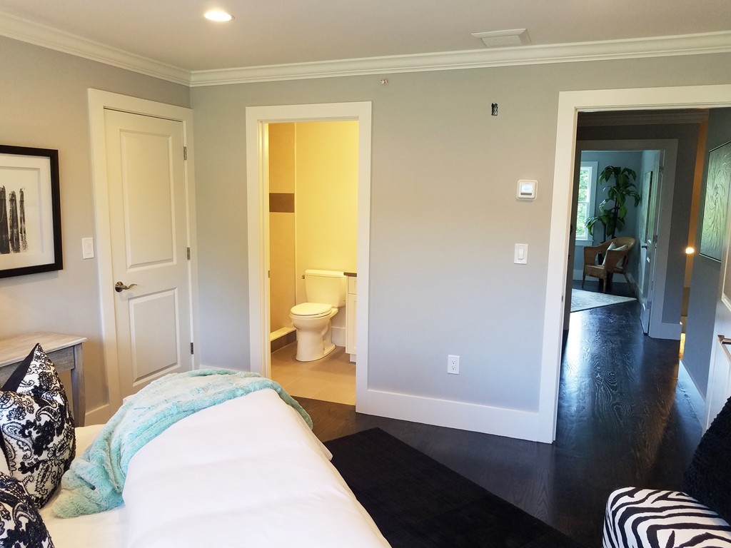 1525 Beacon Street, Unit 3 Newton, MA 02468 - Photo 13 of 21 a spacious bedroom with a bed and wooden floor