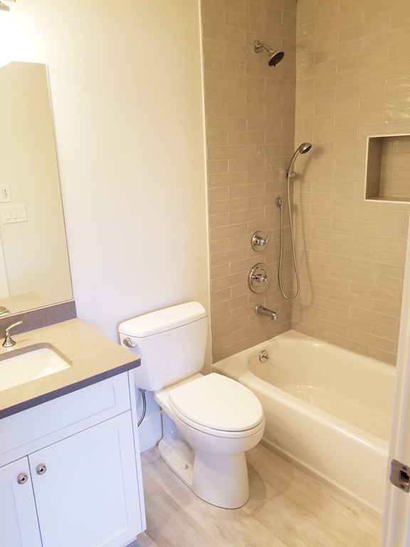 1525 Beacon Street, Unit 3 Newton, MA 02468 - Photo 19 of 21 a white toilet sitting next to a bath tub