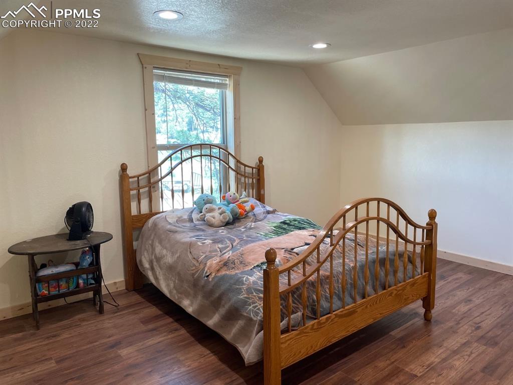188 Keepsake Loop Westcliffe, CO 81252 - Photo 11 of 37 a bedroom with two beds and wooden floor