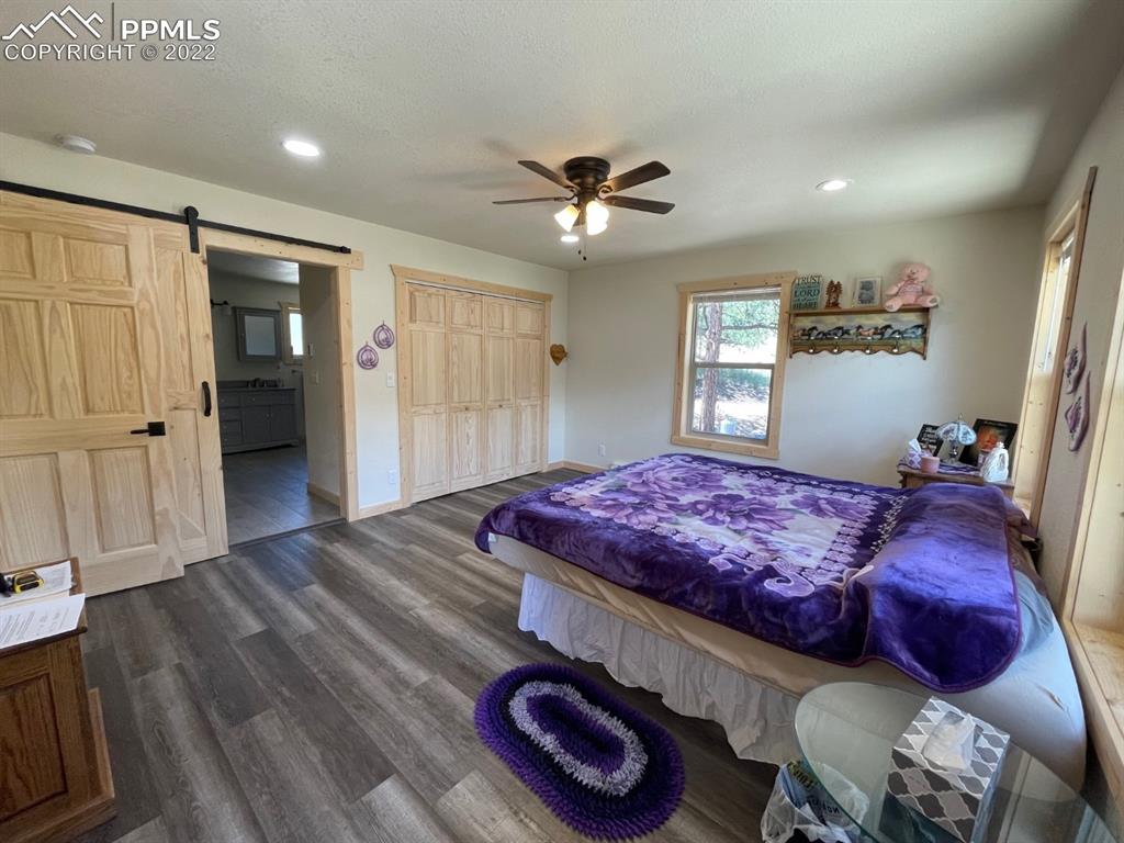 188 Keepsake Loop Westcliffe, CO 81252 - Photo 13 of 37 a spacious bedroom with a bed and a chandelier