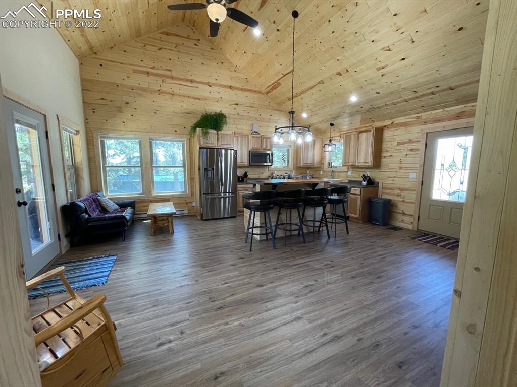 188 Keepsake Loop Westcliffe, CO 81252 - Photo 17 of 37 a view of a dining room with furniture and wooden floor
