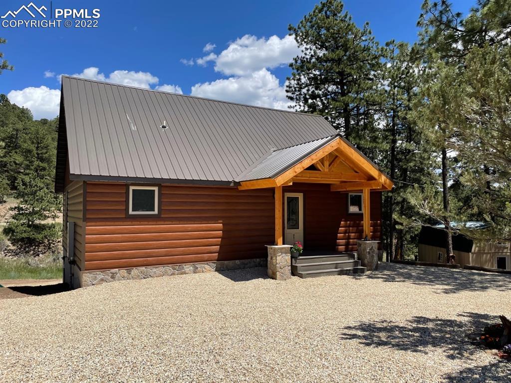 188 Keepsake Loop Westcliffe, CO 81252 - Photo 24 of 37 a front view of a house with a yard and garage