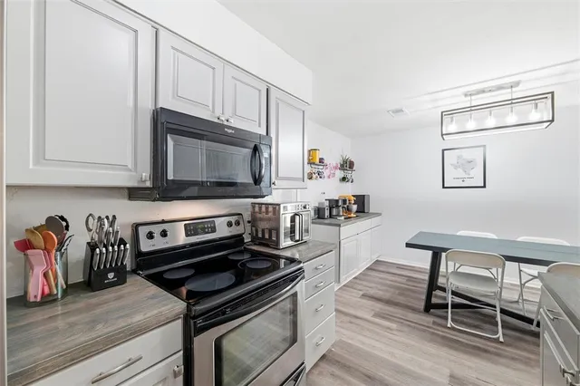 a living room with furniture and a baby crib