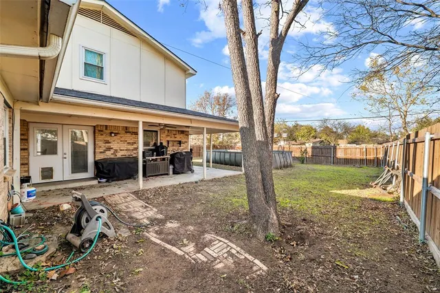 a view of backyard with swimming pool and patio