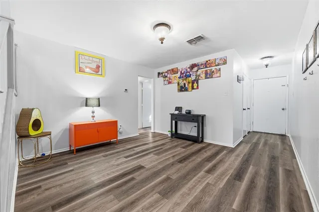a view of entryway and hall with wooden floor