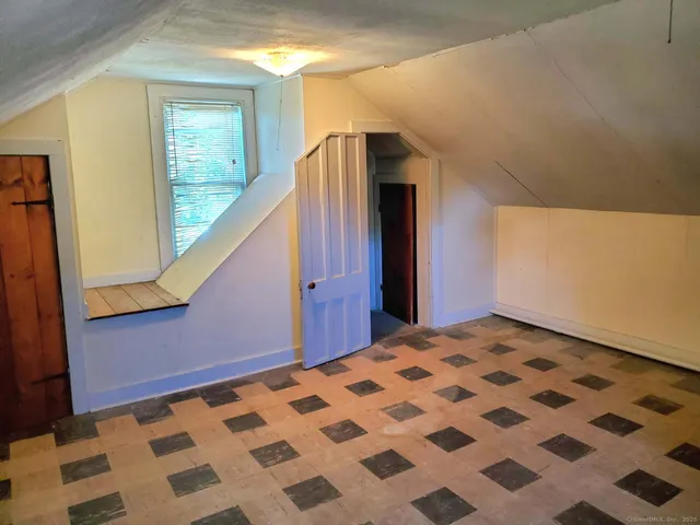 a bedroom with a bed and a mirror