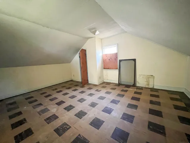 a white house that has a tree in front of it