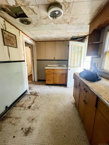 a kitchen with a refrigerator and a sink