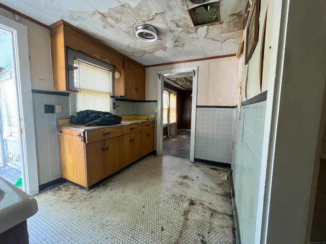 a kitchen with stainless steel appliances granite countertop a refrigerator and a stove