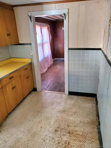 a view of a kitchen with wooden floor and cabinet