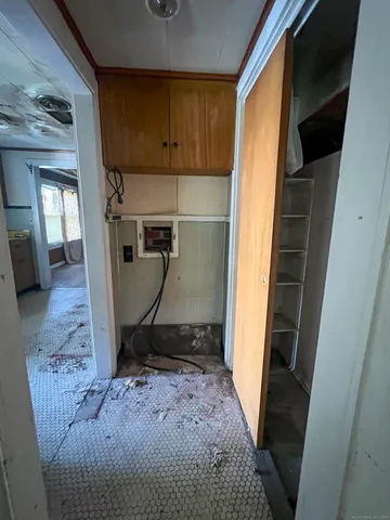 a view of a hallway with wooden floor and a chandelier