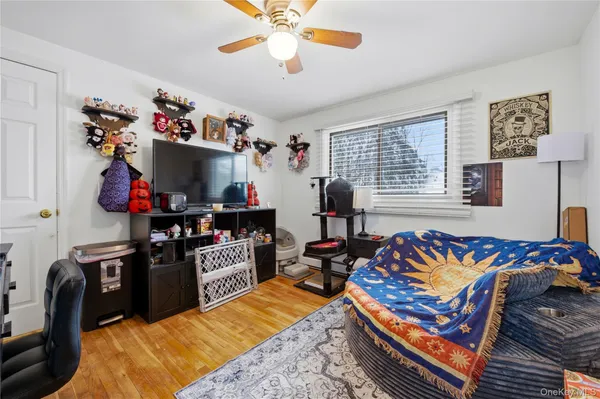 a bedroom with furniture and a flat screen tv