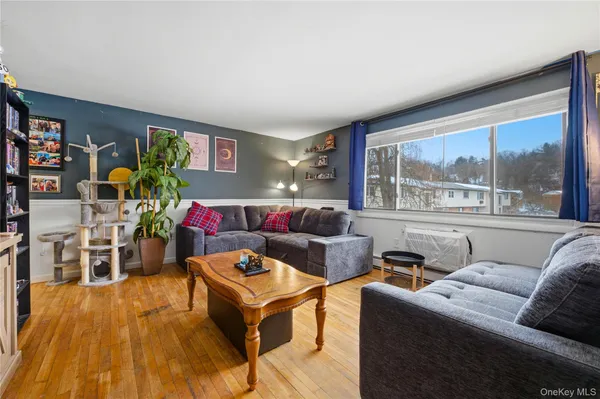 a living room with furniture and a floor to ceiling window