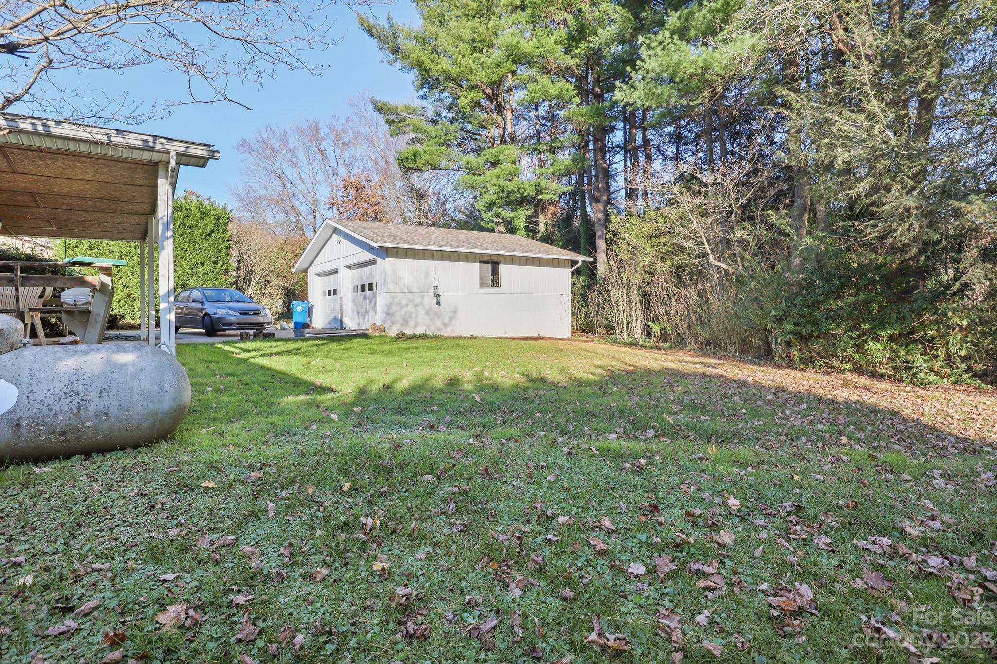 56 Thompson Cove Road, Unit 8 Clyde, NC 28721 - Photo 4 of 21 a view of a house with a backyard and a tree
