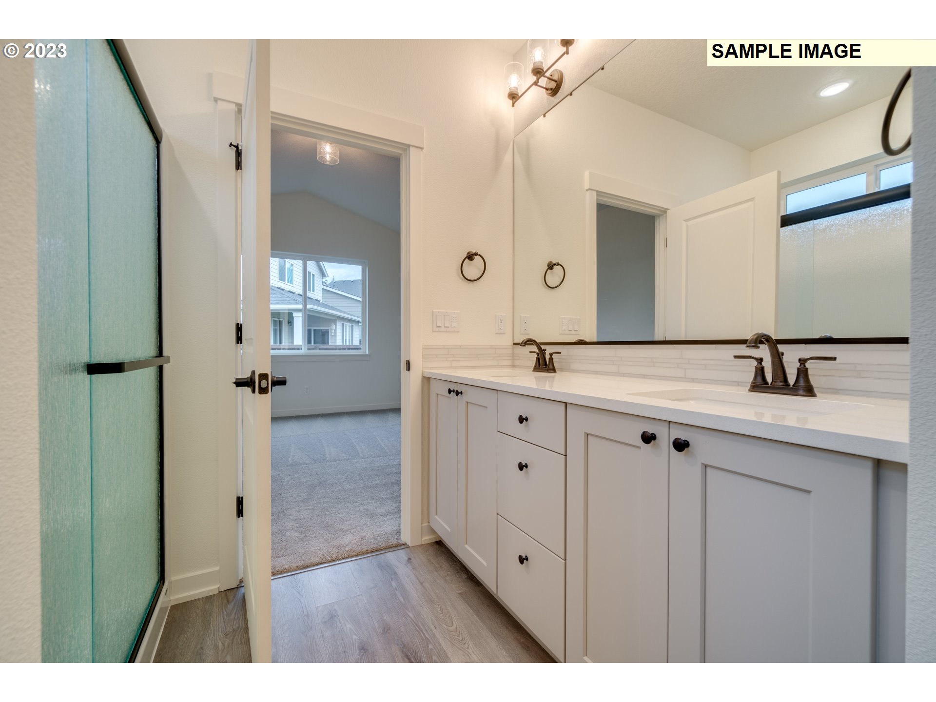 3810 South 44th Avenue Ridgefield, WA 98642 - Photo 6 of 14 a spacious bathroom with a double vanity sink a mirror and a bathtub