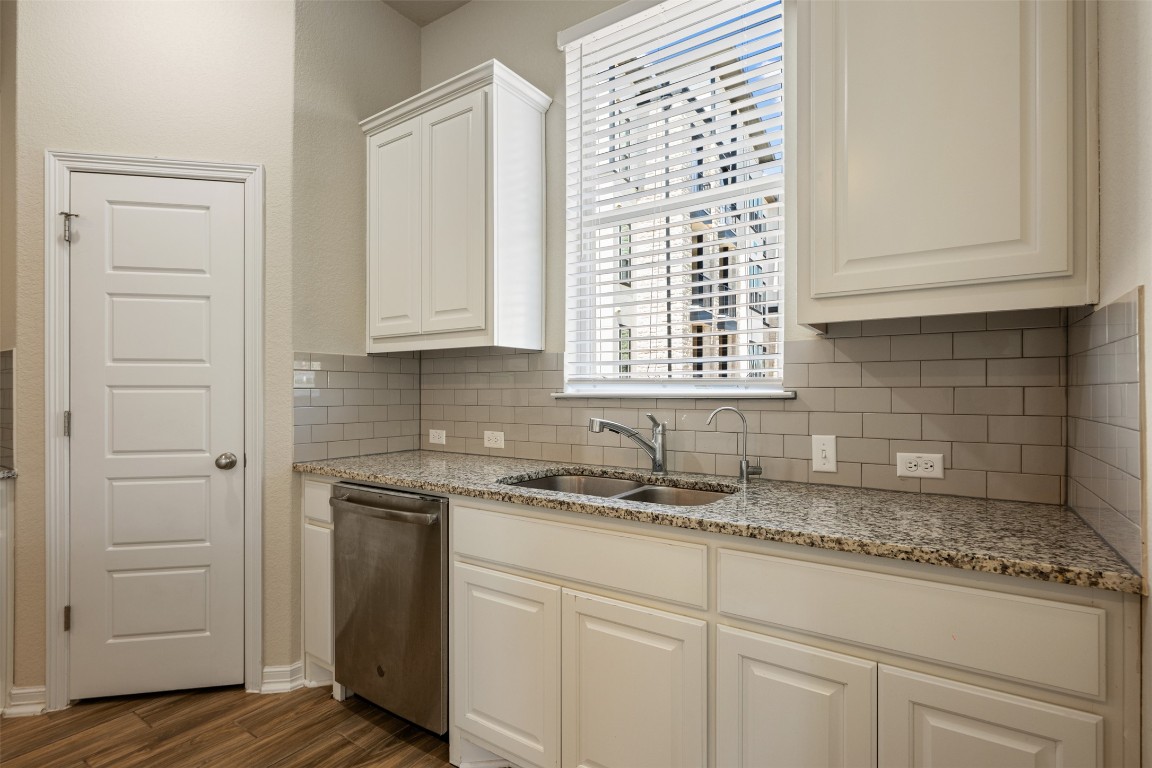 2202 Dillon Pond Lane, Unit B Pflugerville, TX 78660 - Photo 11 of 40 a kitchen with granite countertop white cabinets and a sink