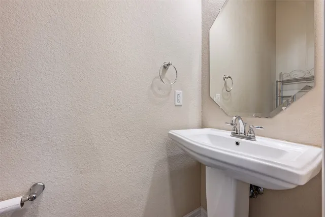 a bathroom with a sink and mirror