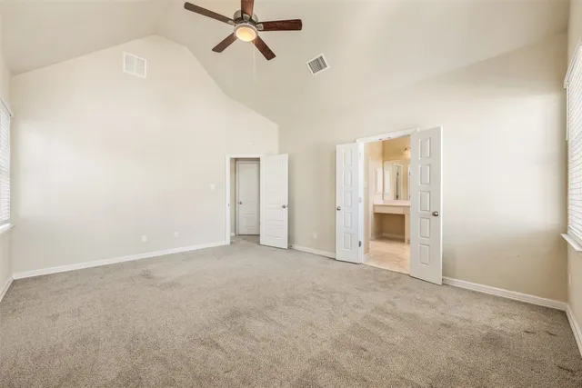 a view of a livingroom with a ceiling fan & entryway