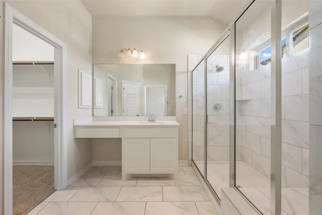 a bathroom with a shower and a sink