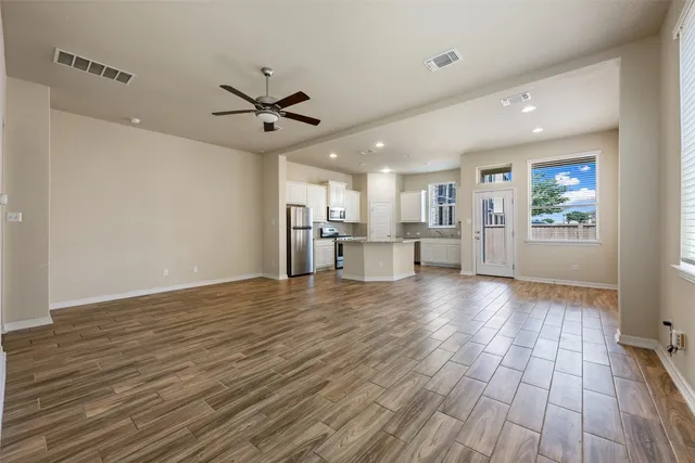 a view of a kitchen with wooden floor and a kitchen