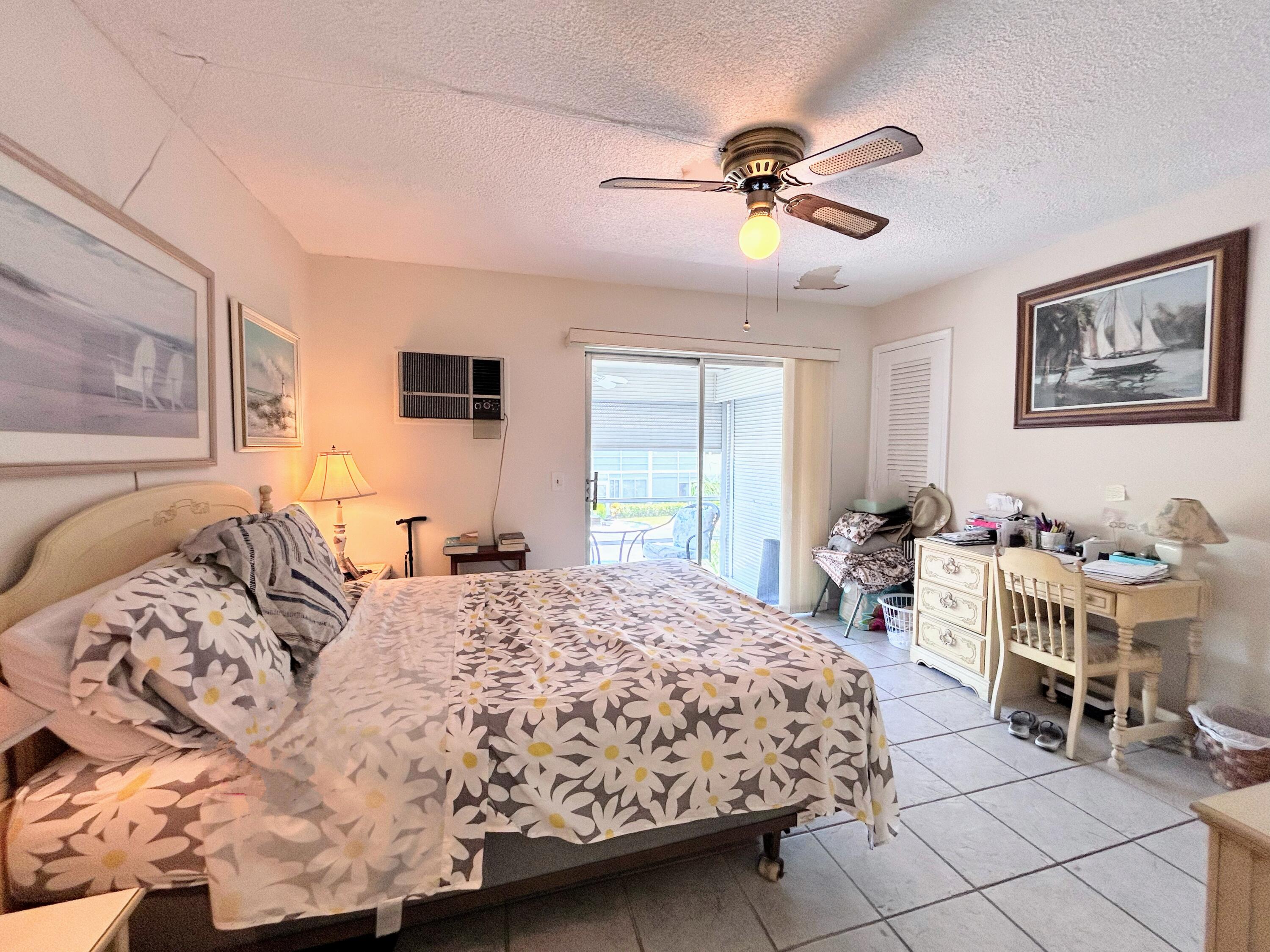 340 Horizon West, Unit 203 Boynton Beach, FL 33435 - Photo 12 of 45 a bedroom with a large bed and a window
