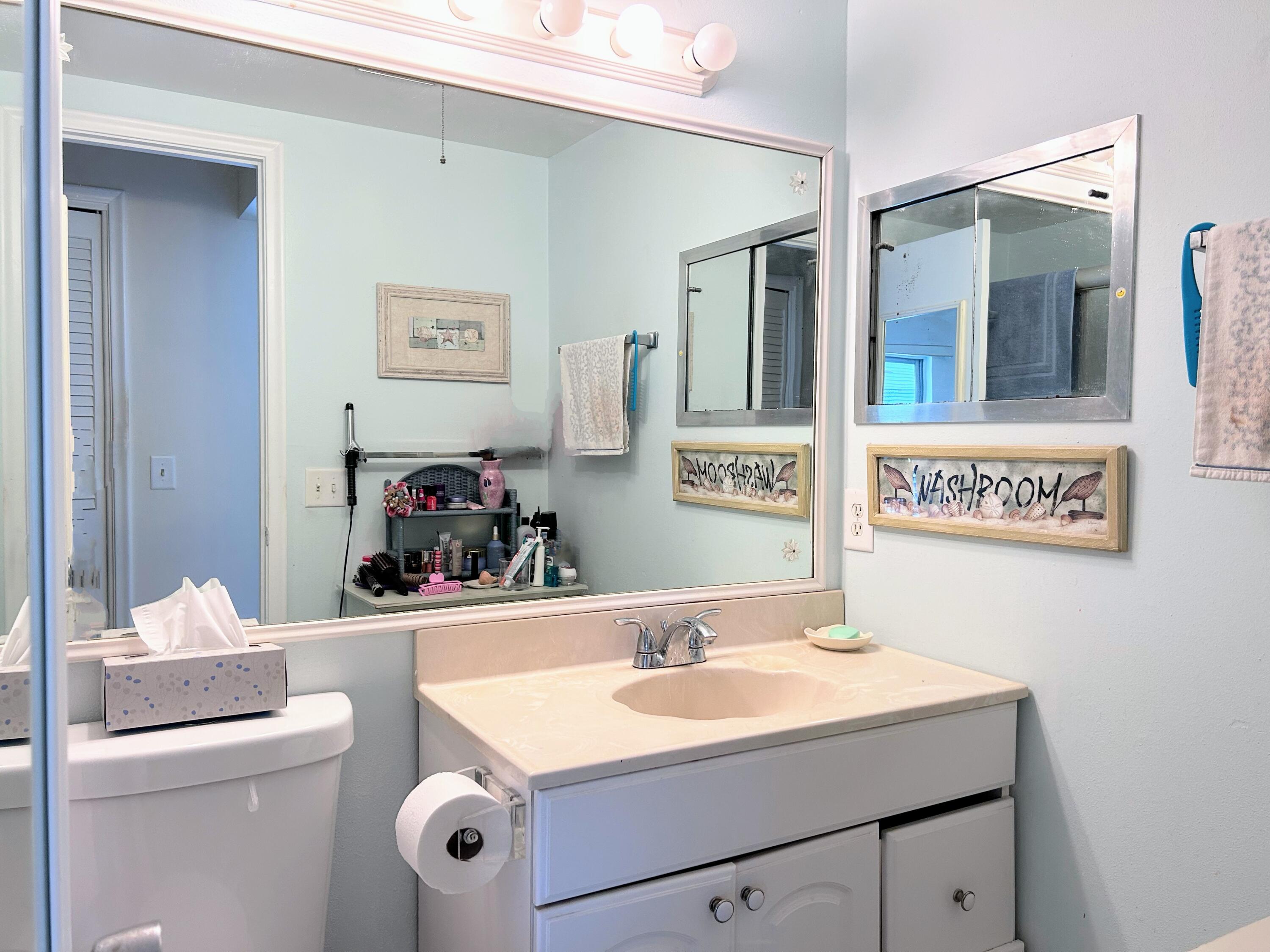 340 Horizon West, Unit 203 Boynton Beach, FL 33435 - Photo 13 of 45 a bathroom with a sink and a mirror
