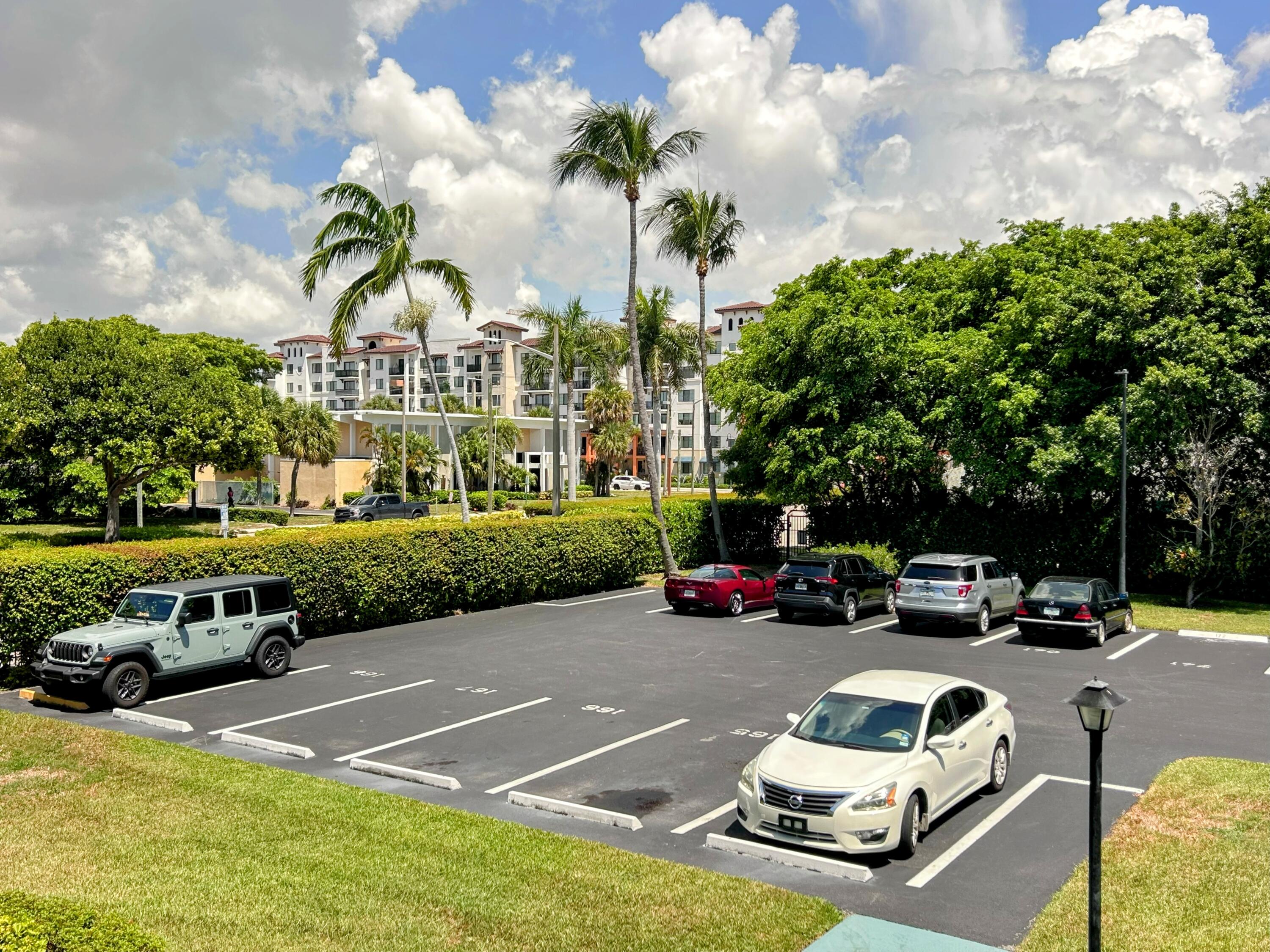 340 Horizon West, Unit 203 Boynton Beach, FL 33435 - Photo 18 of 45 a view of a street with cars parked