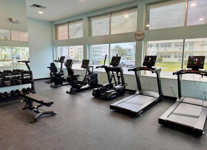 340 Horizon West, Unit 203 Boynton Beach, FL 33435 - Photo 25 of 45 a room with gym equipment and large windows