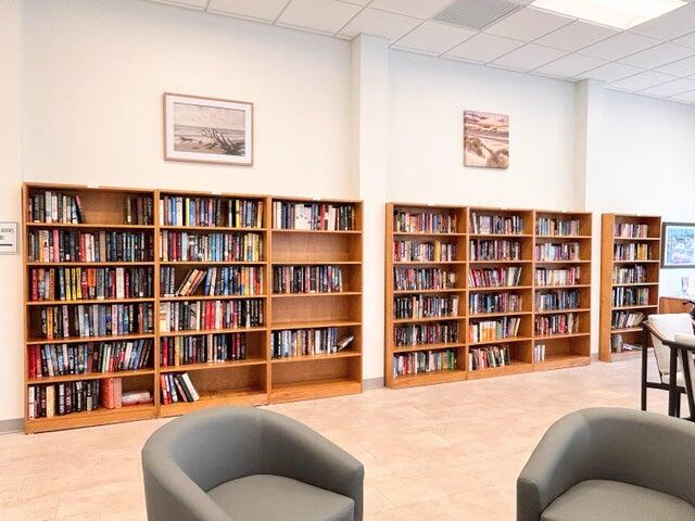 340 Horizon West, Unit 203 Boynton Beach, FL 33435 - Photo 27 of 45 a living room with furniture and a book shelf