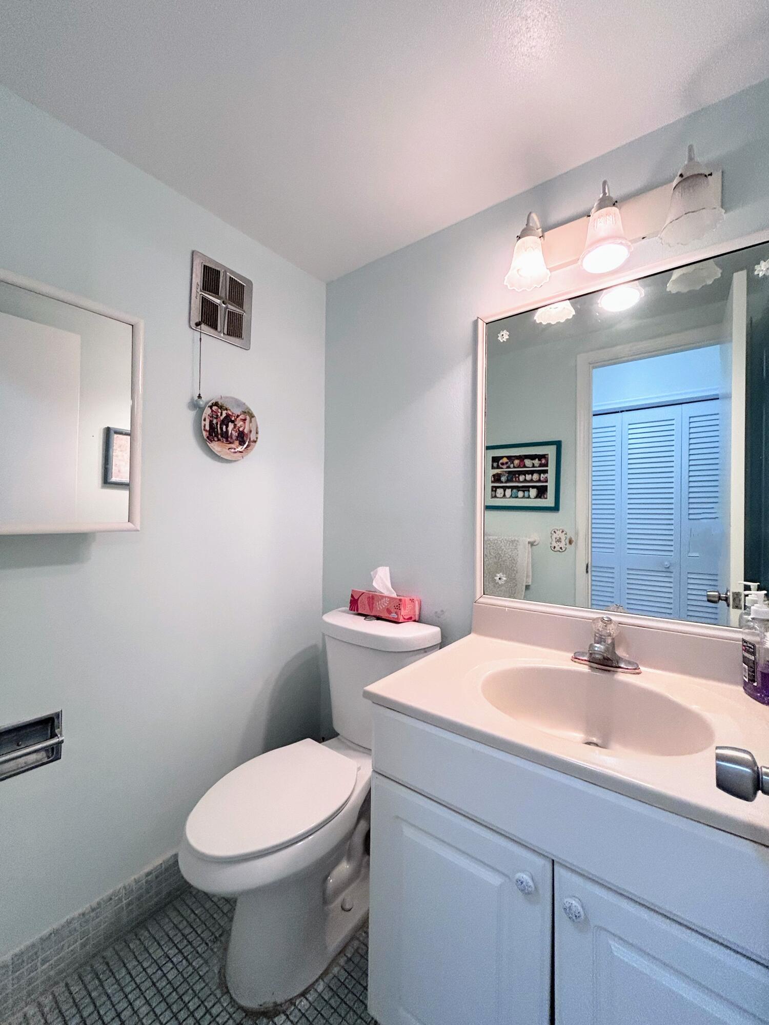 340 Horizon West, Unit 203 Boynton Beach, FL 33435 - Photo 9 of 45 a bathroom with a sink and mirror