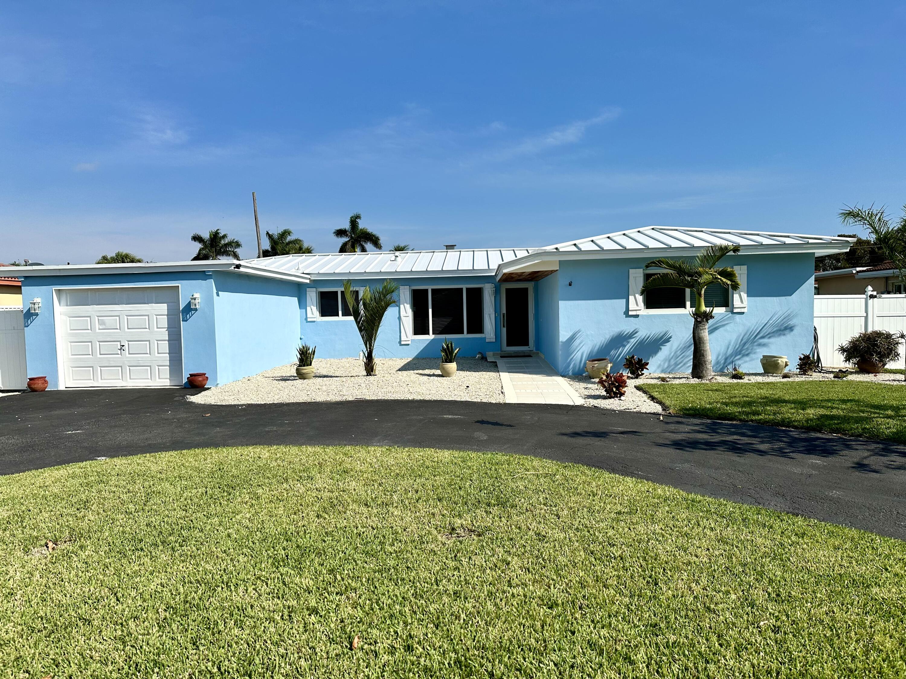 469 Northeast 30th Street Boca Raton, FL 33431 - Photo 1 of 24 a view of a swimming pool with an outdoor seating