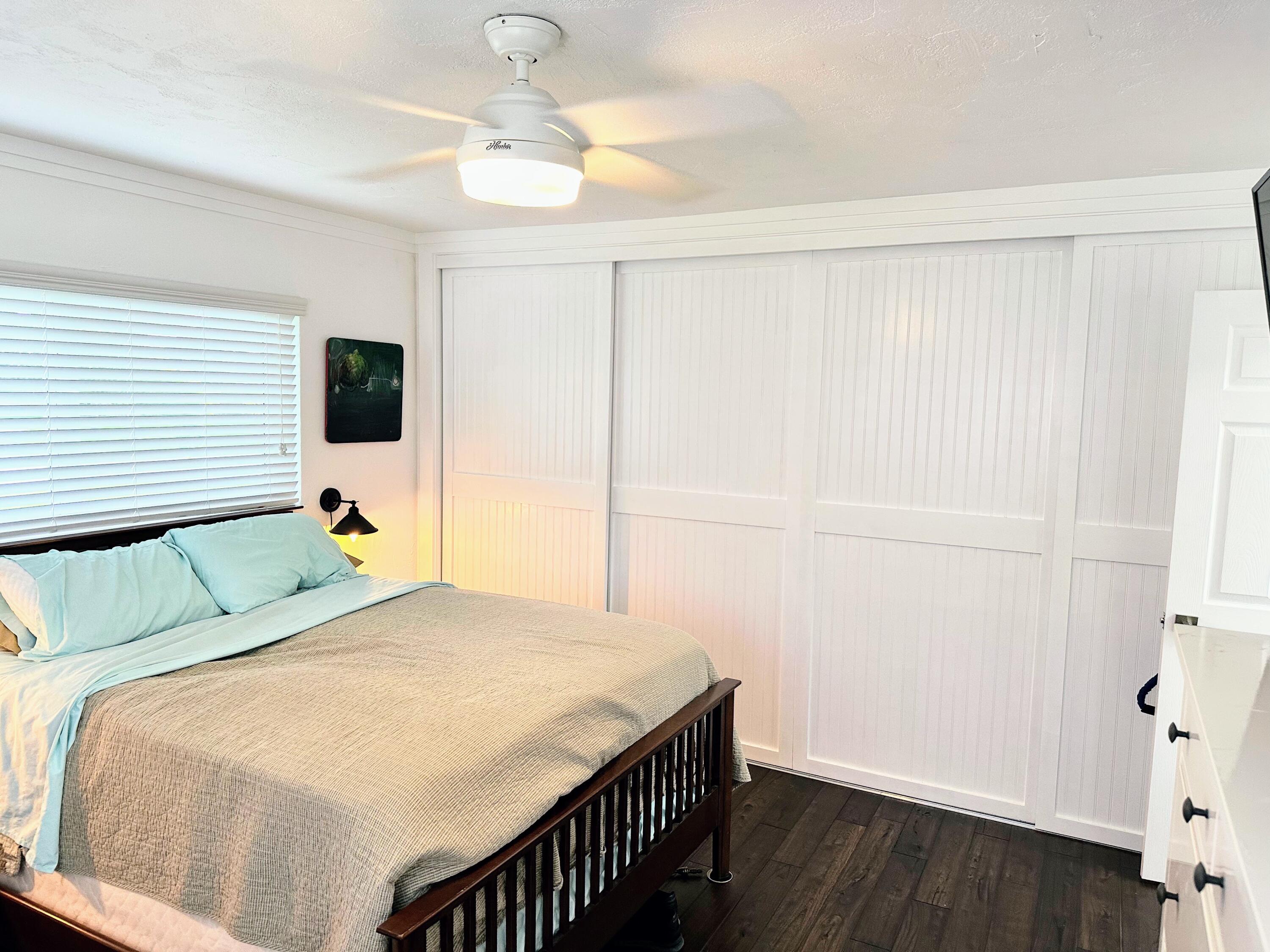 469 Northeast 30th Street Boca Raton, FL 33431 - Photo 11 of 24 a bedroom with a bed and a flat tv screen on dresser